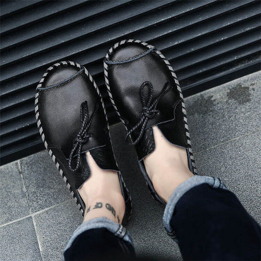 Top view of stylish black slip-on shoes with braided details and lace accents, perfect for casual outings.