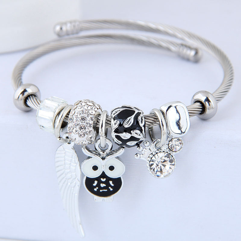 Product information: These stunning Owl & Angel Wings Charm Bracelets come in 5 different colors to fit any style! Made with high-quality steel alloy, sparkling rhinestones, and a variety of charming colors, this accessory is truly one-of-a-kind and will