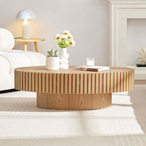 Modern oval drum coffee table made of wood, featuring a unique ribbed design, ideal for living rooms or outdoor spaces.