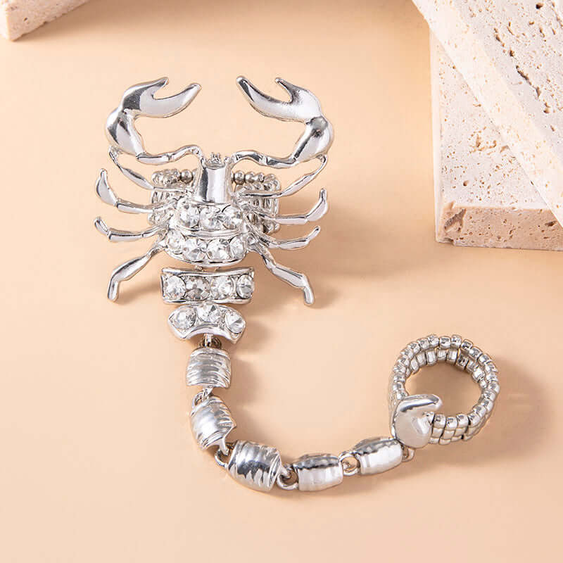 Make a statement with this silver-tone scorpion piece, blending punk, vintage, and hip hop styles. Crafted with rhinestones, zinc alloy, and an elastic band