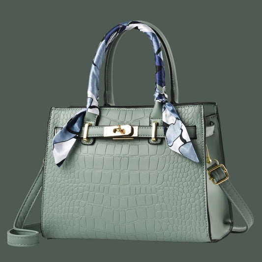 Green handbag with a decorative scarf on a white background