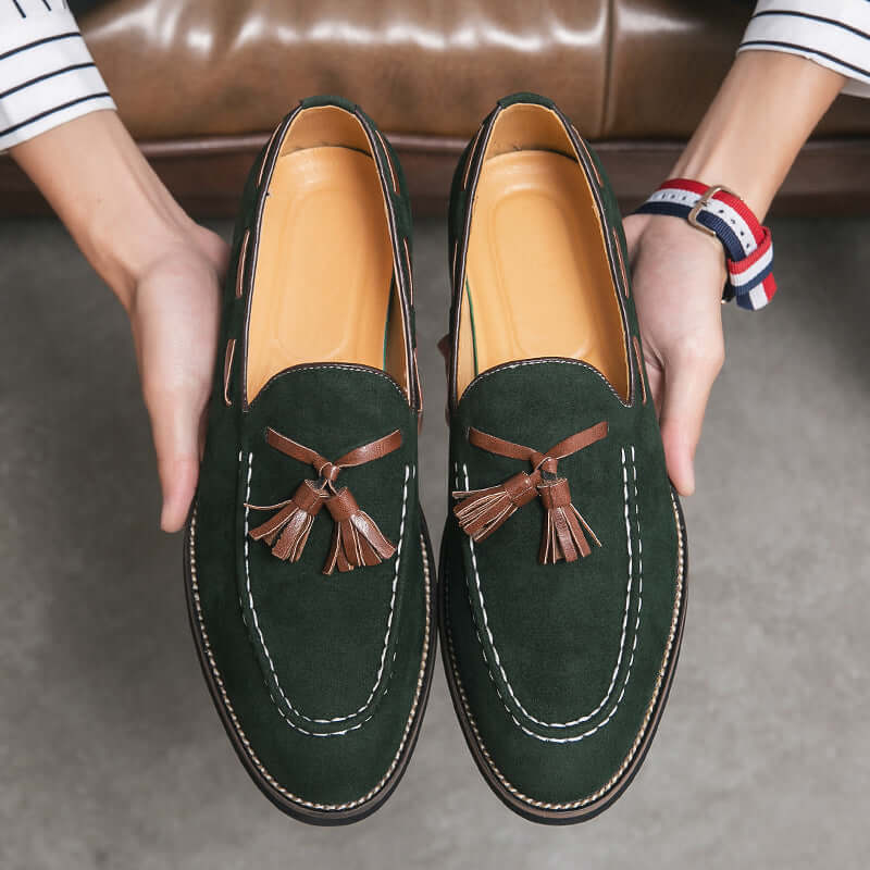 Men's casual suede slip-on shoes in dark green with tassel detail, ideal for business casual outfits.