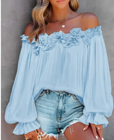 Light blue women's off-shoulder long sleeve top with ruffled details, styled with denim shorts for a casual look.