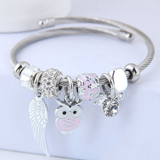 Product information: These stunning Owl & Angel Wings Charm Bracelets come in 5 different colors to fit any style! Made with high-quality steel alloy, sparkling rhinestones, and a variety of charming colors, this accessory is truly one-of-a-kind and will