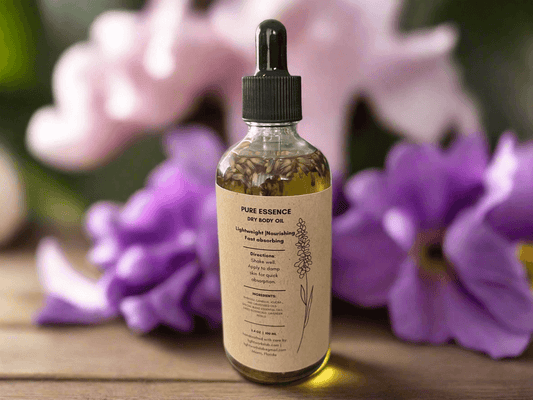 Pure Essence dry body oil bottle with flowers highlighting dry body oil benefits.