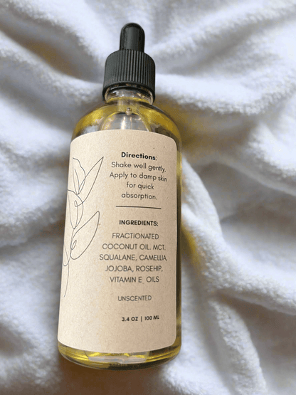 Bottle of skincare product with dropper on a white fabric background