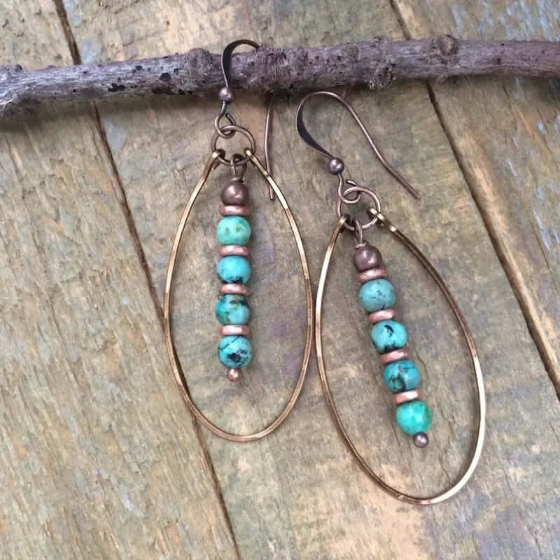 Women's Beaded Bohemian Vintage Earrings featuring turquoise blue stones and gold accents on a natural wood background.