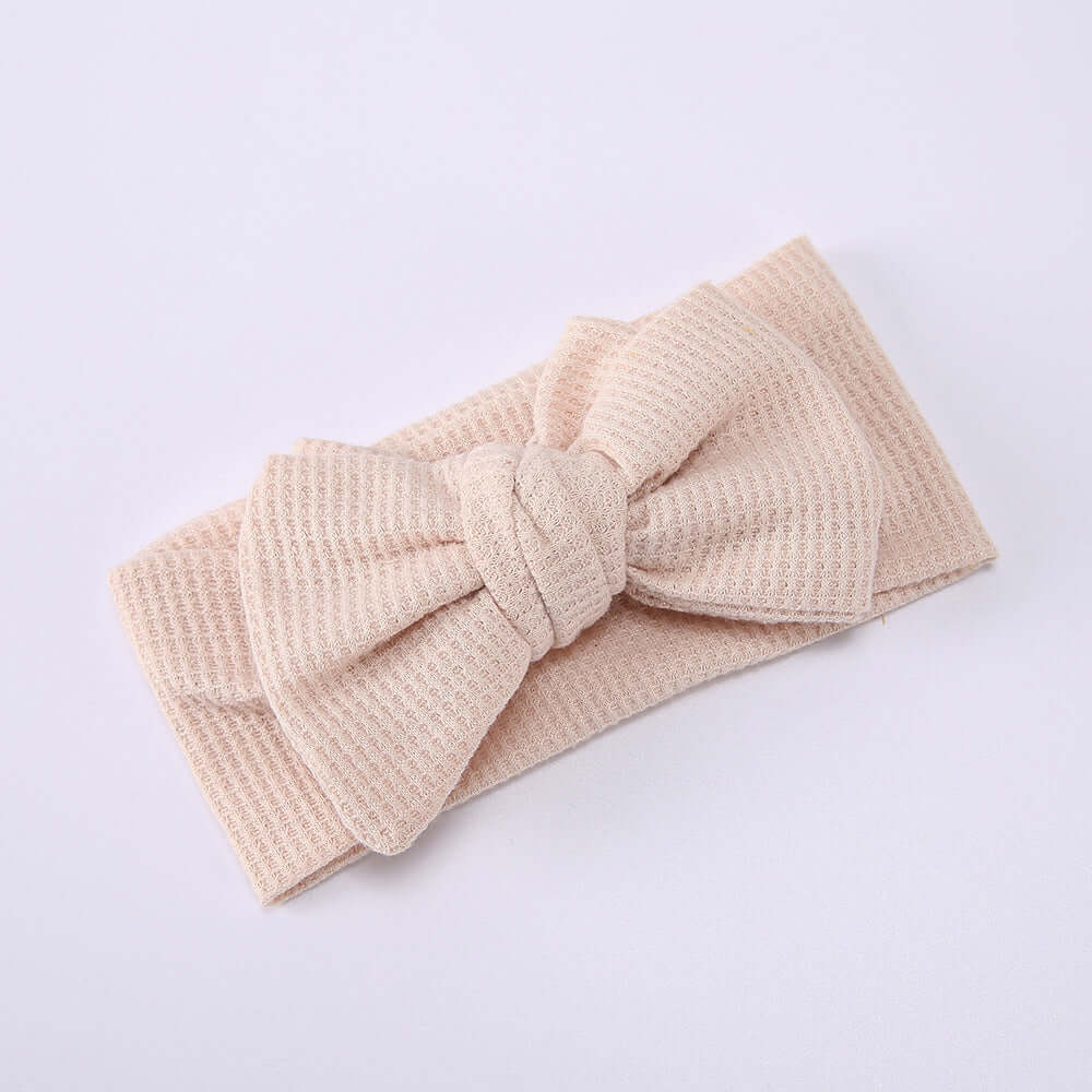 Children's Waffle Knit Oversized Bow Headband in soft beige color, perfect for adding charm to your little one's outfit.