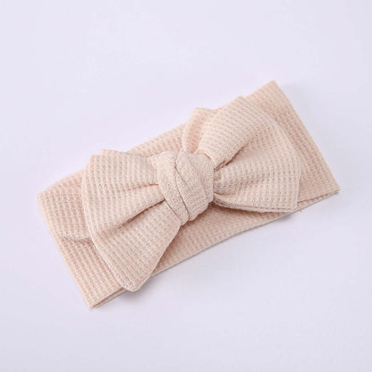 Children's Waffle Knit Oversized Bow Headband in soft beige color, perfect for adding charm to your little one's outfit.