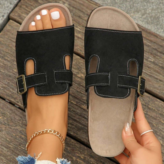 Black women's suede belt buckle sandals with slip-on design and adjustable strap, perfect for casual outings.