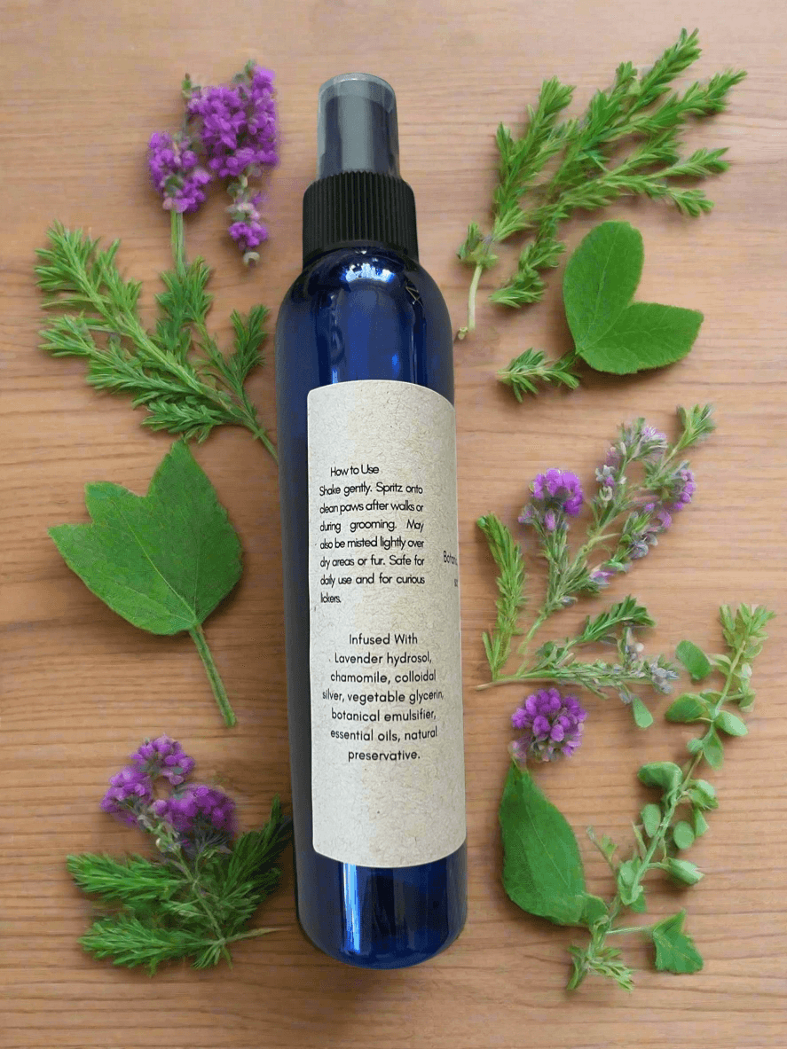 Herbal Paw Mist 8 oz. bottle with natural herbs and instructions on a wooden surface.