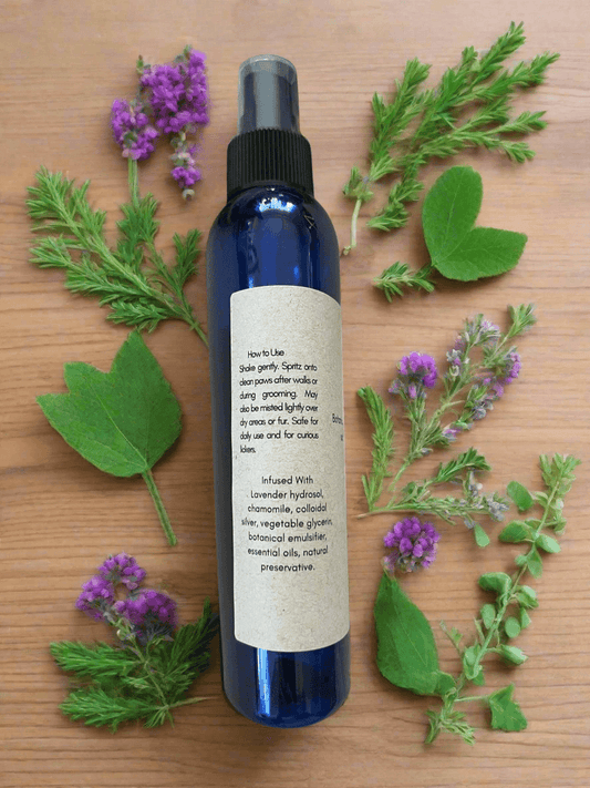 Herbal Paw Mist 8 oz. bottle with natural herbs and instructions on a wooden surface.