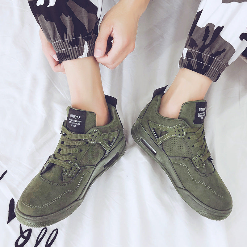 Green sneakers worn with camouflage pants on a white background