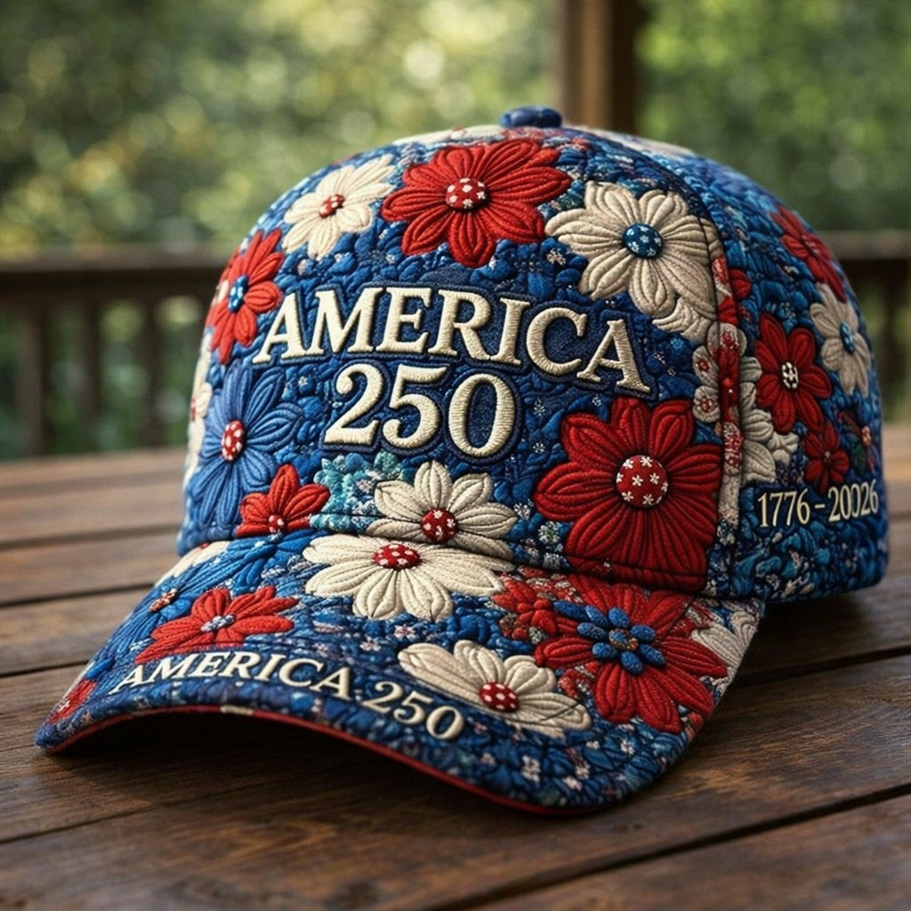 Decorative cap with floral patterns and 'AMERICA 250' text on a wooden surface