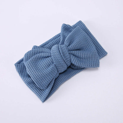 Children's Waffle Knit Oversized Bow Headband in blue, crafted from soft waffle knit fabric.