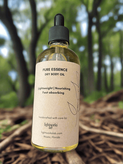 Bottle of pure essence dry body oil with a natural background