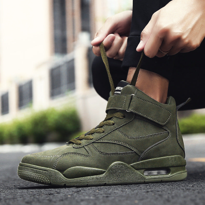 Person wearing a green high-top sneaker with a blurred urban background