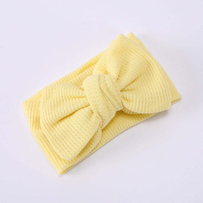 Children's Waffle Knit Oversized Bow Headband in soft yellow fabric, perfect for little girls' outfits.