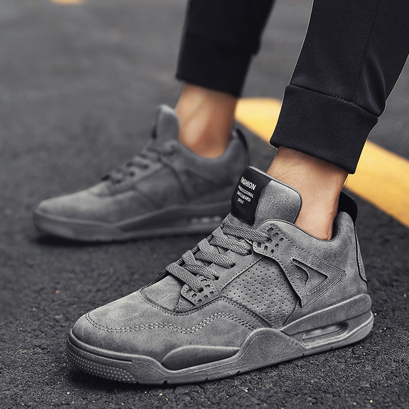 Gray sneakers worn on a dark surface