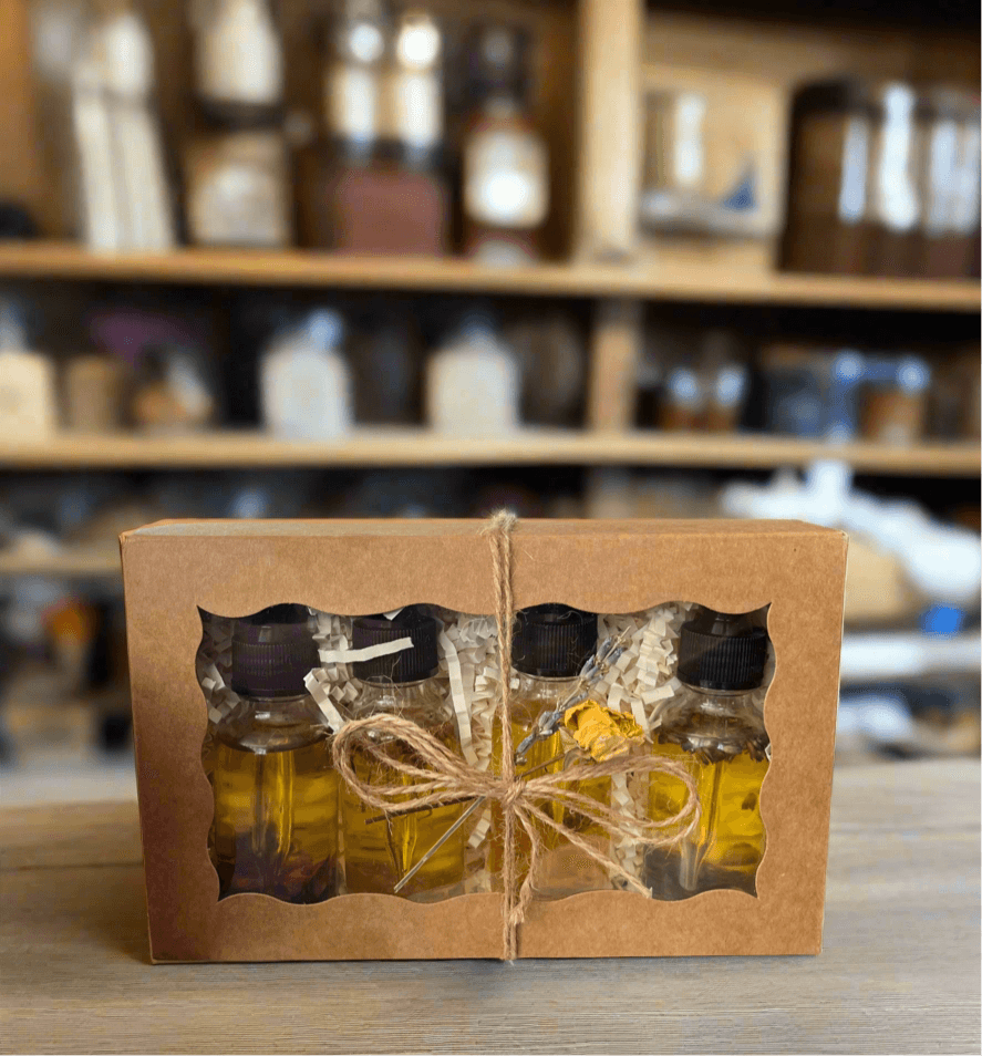 Botanical Dry Body Oil Sampler Set 4x1 oz. displayed in a recyclable box with a view of four 1-oz bottles.