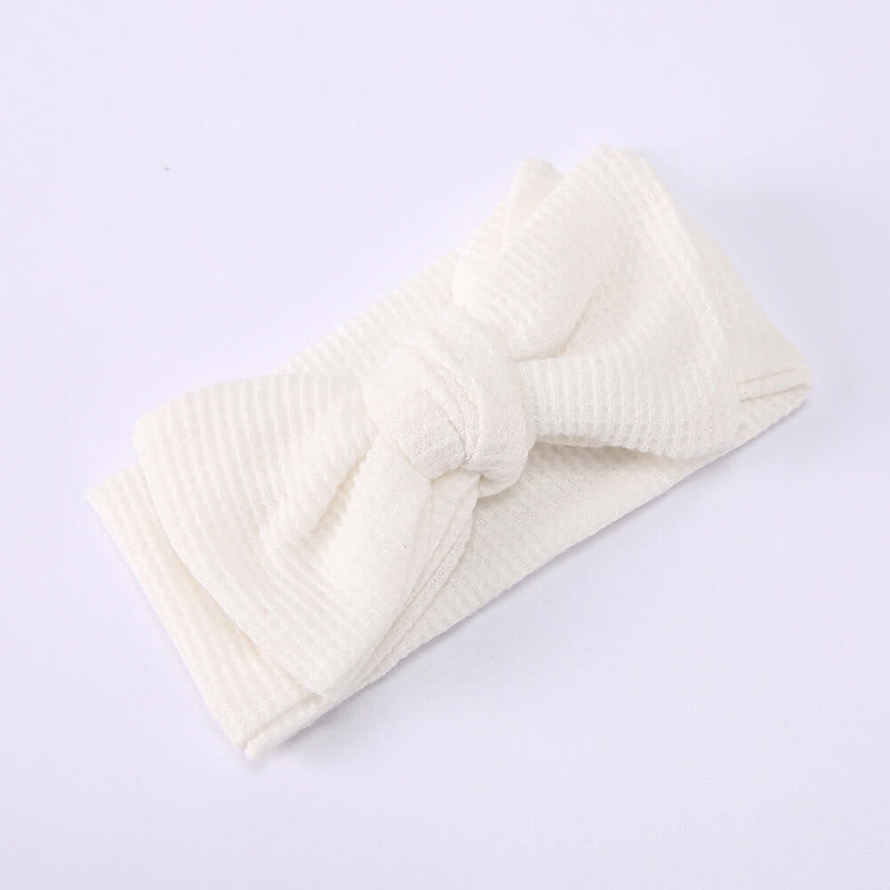 Children's Waffle Knit Oversized Bow Headband in soft white fabric, perfect for little girls' stylish outfits.