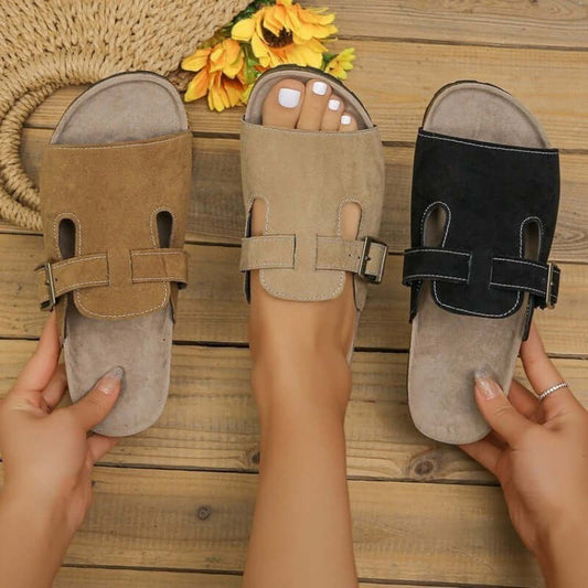 Women's suede belt buckle sandals in brown, beige, and black, showcasing adjustable fit and stylish design.