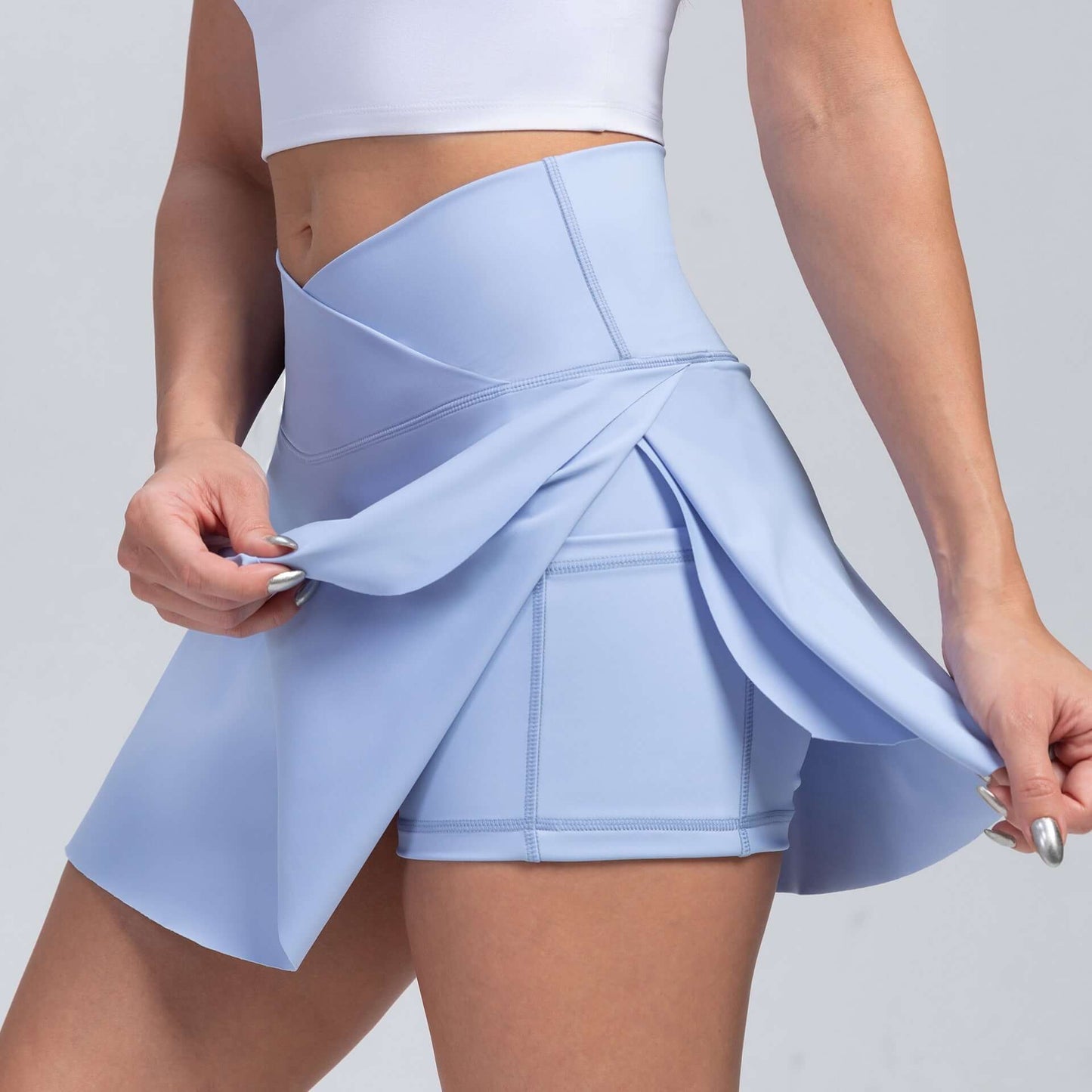 Women's Yoga Skorts in light blue, featuring a stylish skirt overlay for comfort and modest coverage.