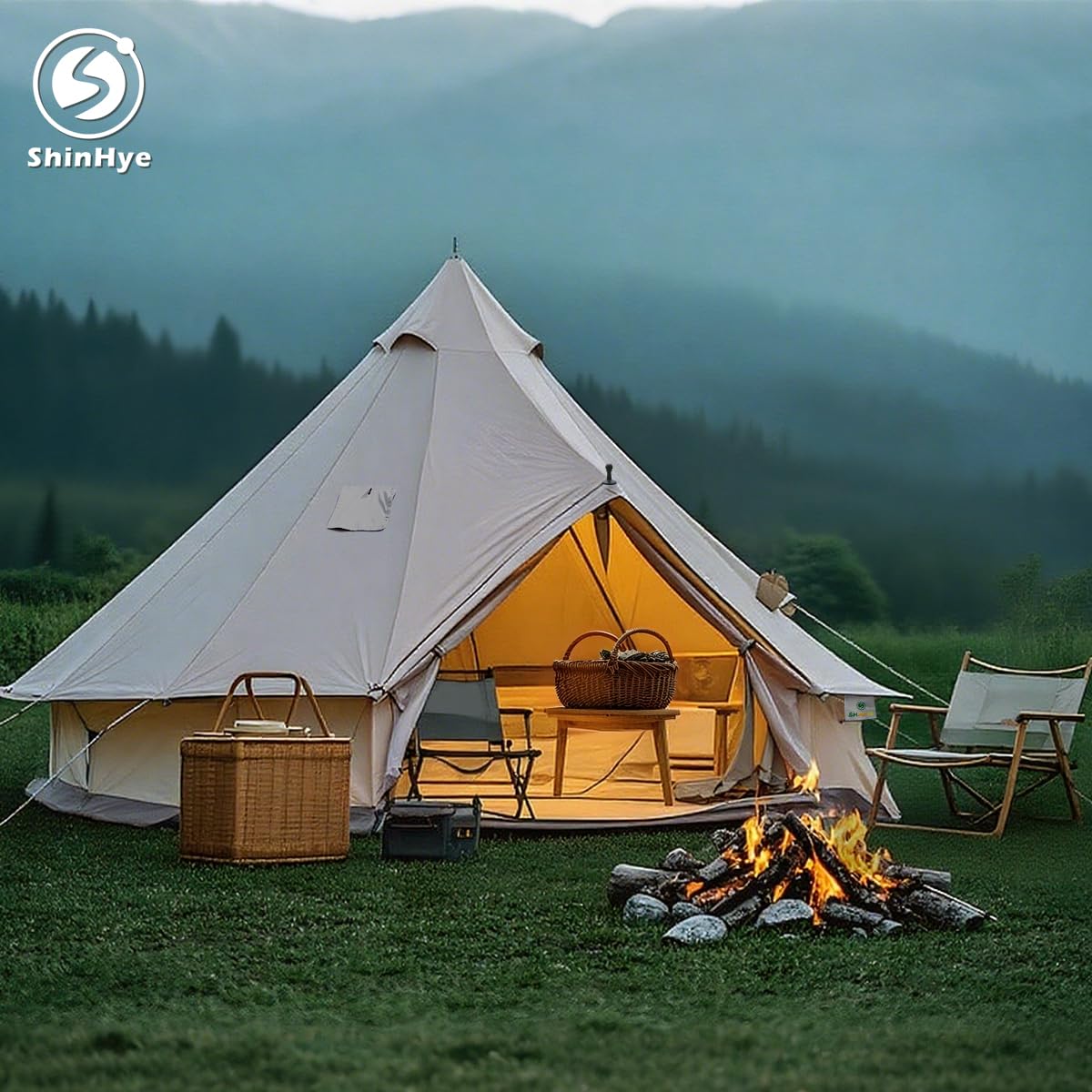 Camping scene with a tent, chairs, and fire pit in a mountainous area, featuring ShinHye logo.
