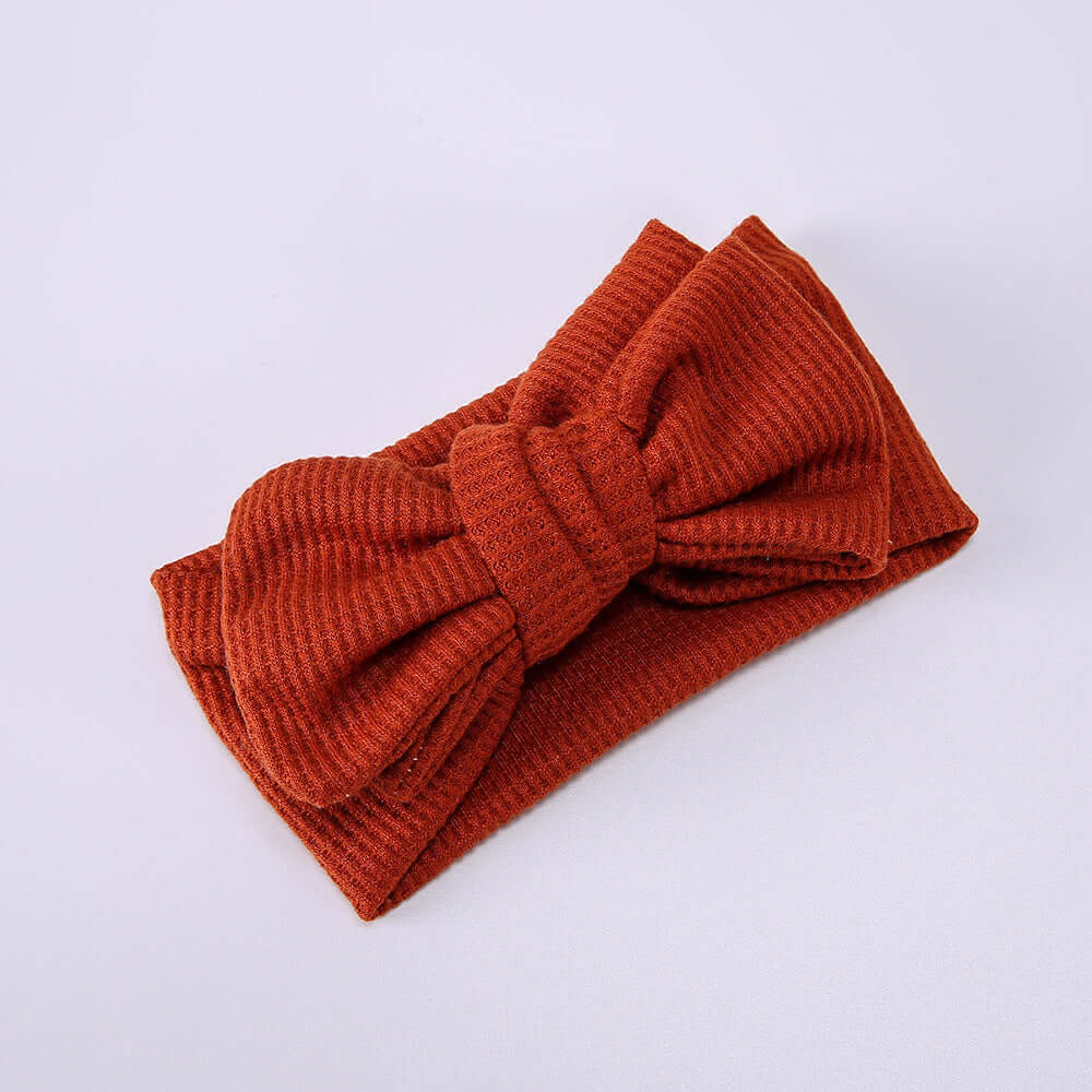Children's Waffle Knit Oversized Bow Headband in rust color, soft texture, perfect for little girls.