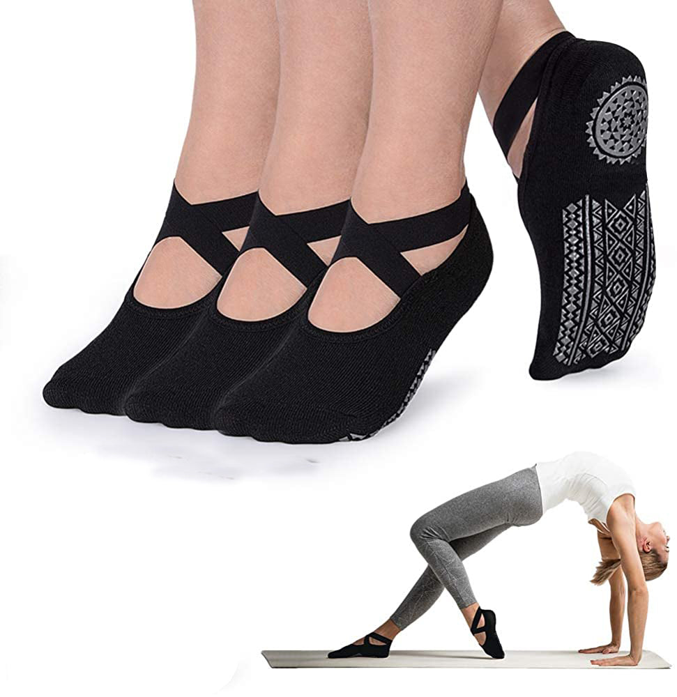 Black yoga socks with cut-out design on a white background, with a person in a yoga pose.