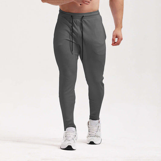 Men's breathable workout pants in grey, designed for comfort and flexibility during athletic activities.