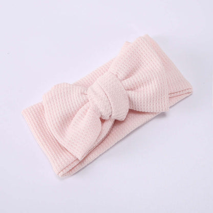 Children's Waffle Knit Oversized Bow Headband in soft pink with a large bow detail.