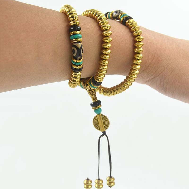 "Enhance your collection with 6.5mm Nepalese Copper Beads. 108 solid brass pieces with agate dzi, turquoise & copper accents. Unisex & exquisite!"