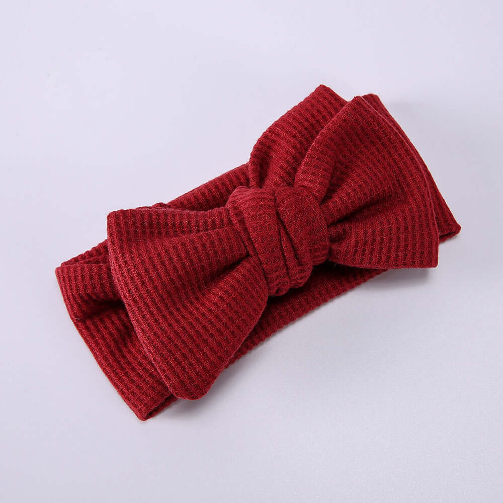 Children's Waffle Knit Oversized Bow Headband in red, perfect for adding playful charm to little ones' outfits.