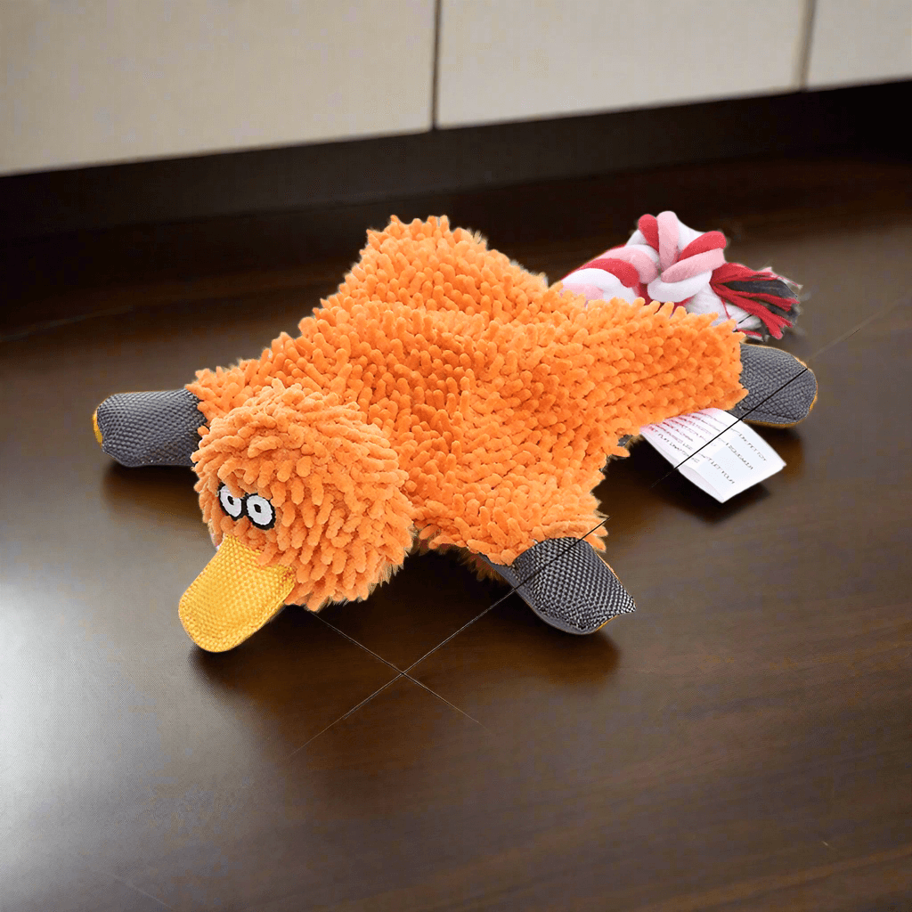 Squeaky Corduroy Chew Toys For Dogs in the shape of a fun orange duck with plush texture.