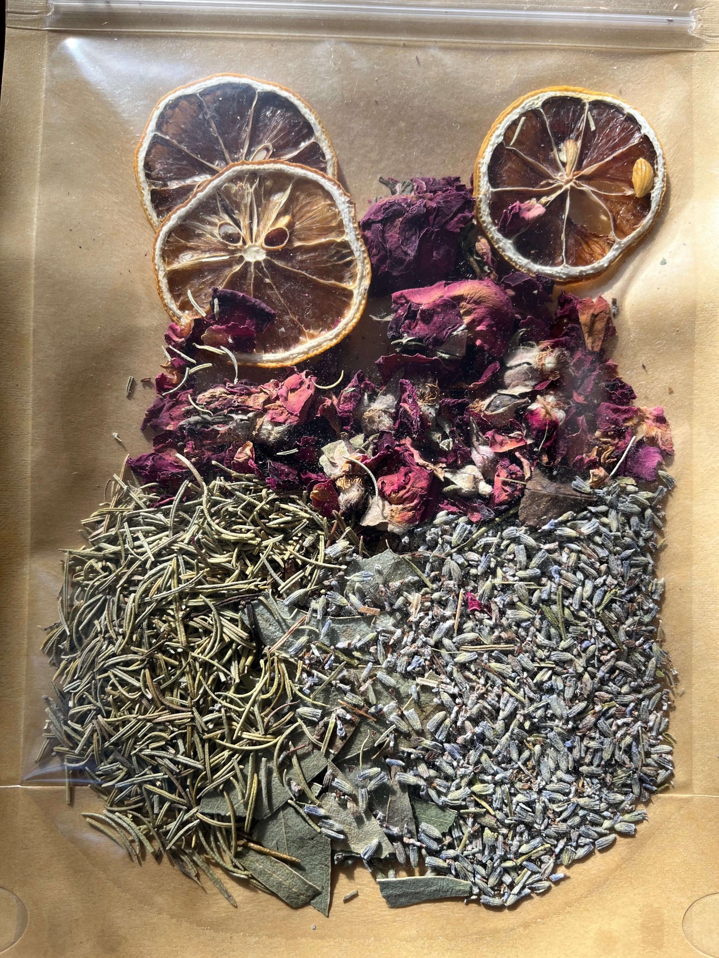 Seasonal Dry or Simmering Potpourris featuring dried herbs, flowers, and citrus slices in a clear bag.