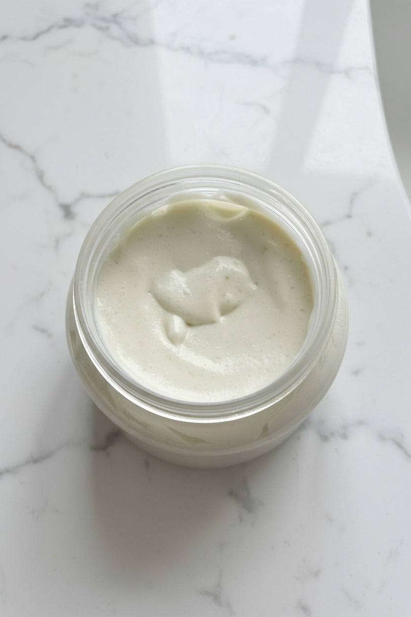 Container of white cream on a brown surface