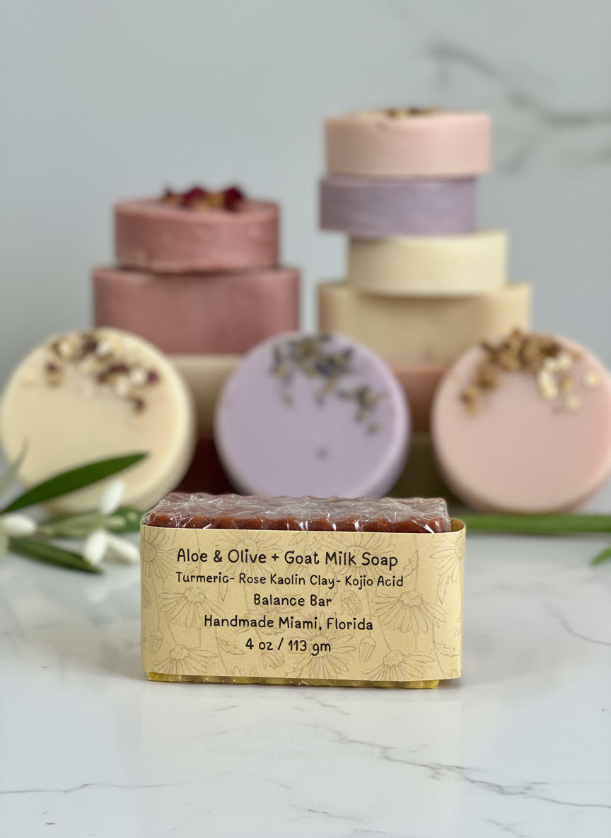 Handmade soap bars with labels on a marble surface
