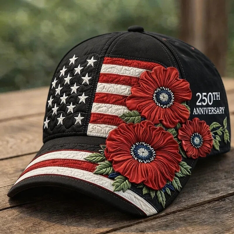 Cap with American flag design and red flowers on a wooden surface