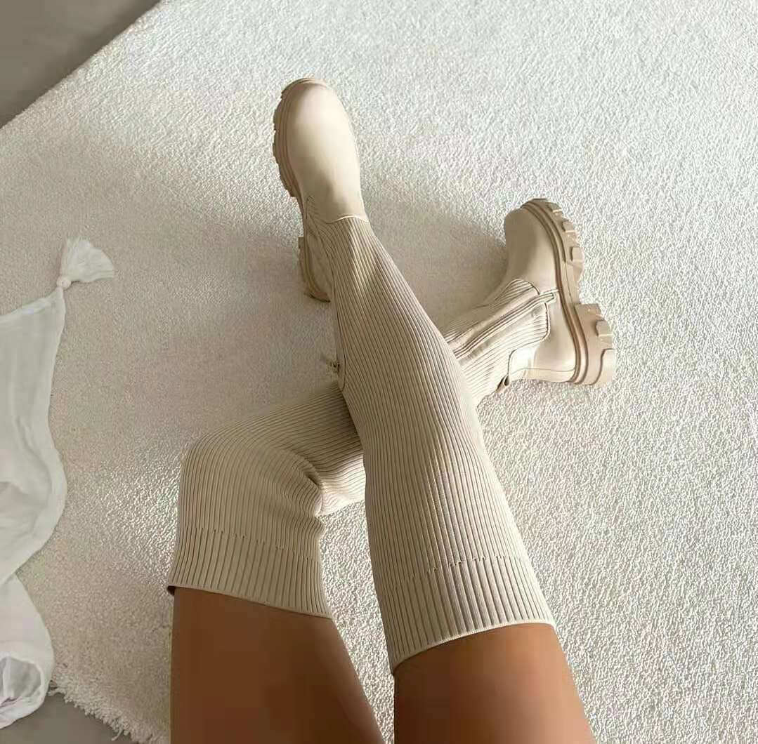 Over-Knee Sock Boots with Side Zipper in beige on a soft rug.