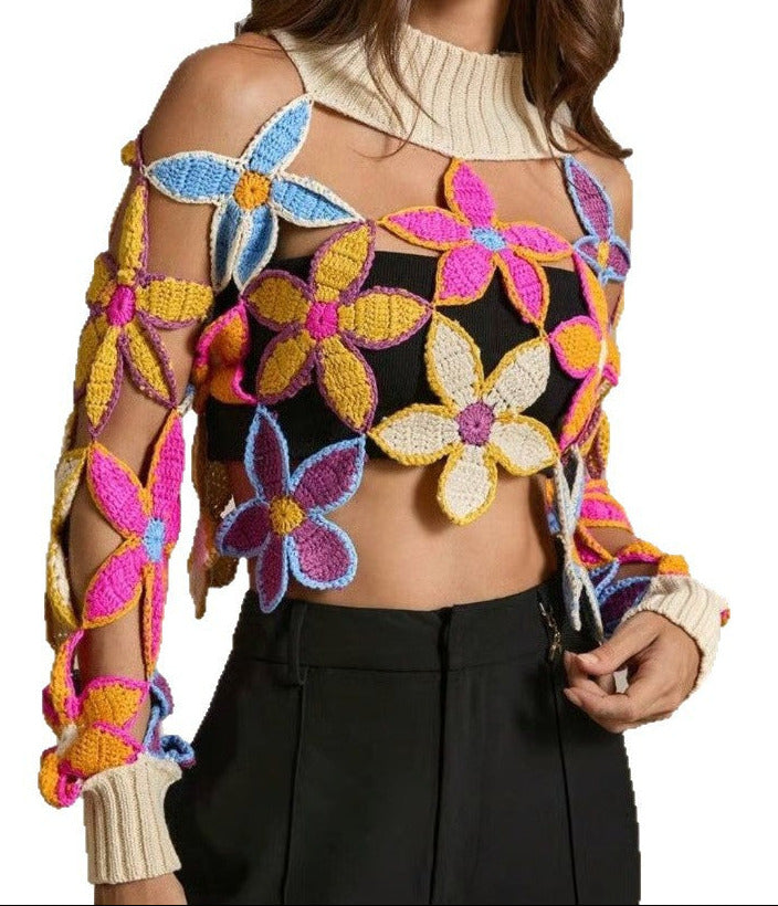 Woman wearing a colorful floral-patterned sweater with a plain background