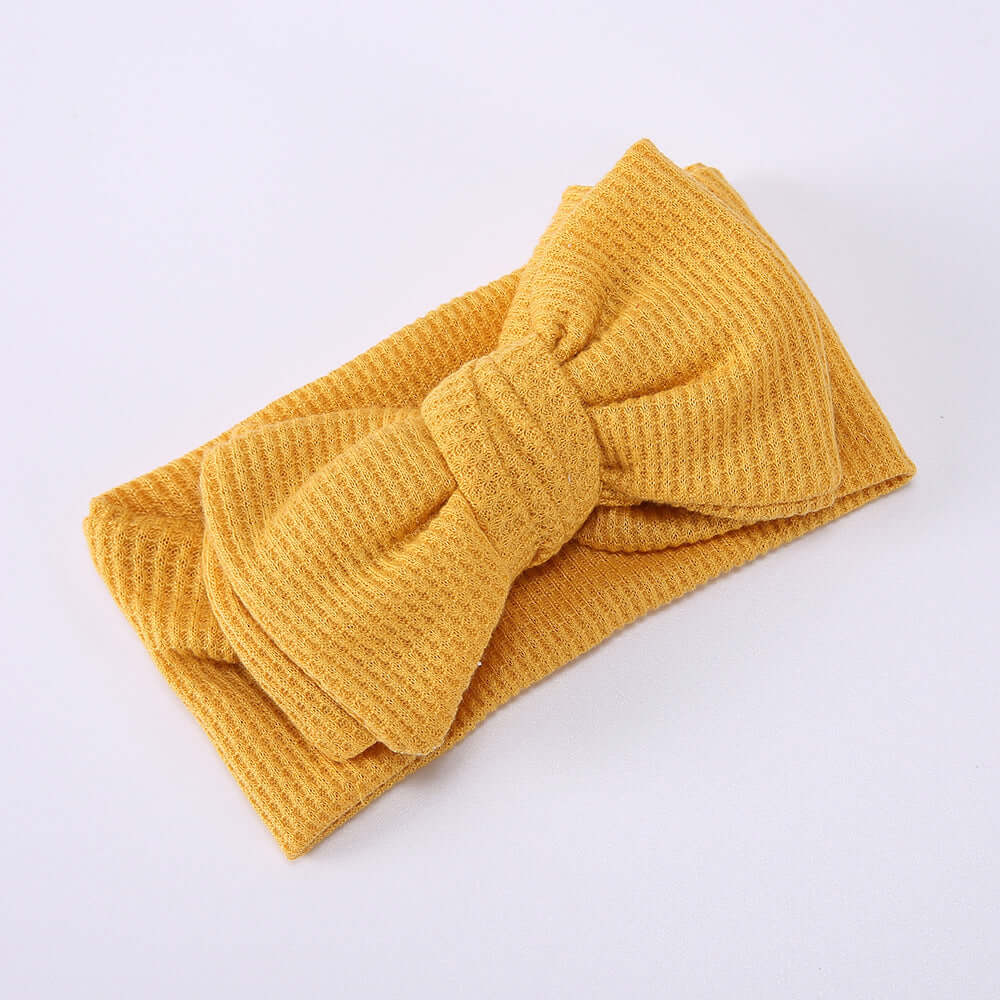 Children's Waffle Knit Oversized Bow Headband in cheerful yellow color, perfect for little girls.