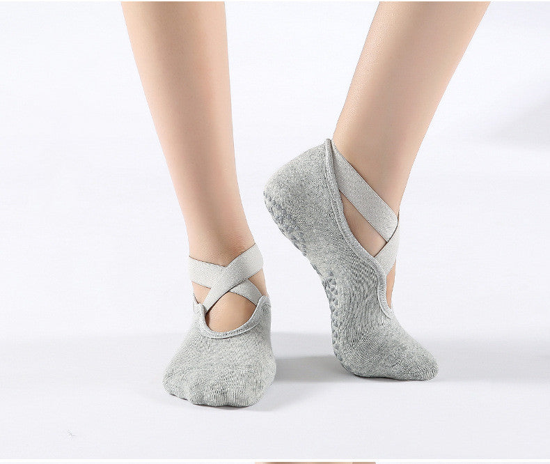 Gray ballet-style socks worn on feet against a white background
