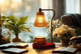 Wickless Candles - Celebrate Milestones displayed beside a lamp in a cozy setting with plants and books.