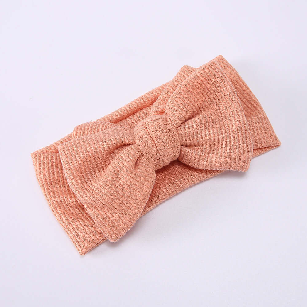 Children's Waffle Knit Oversized Bow Headband in soft peach color with a large bow design