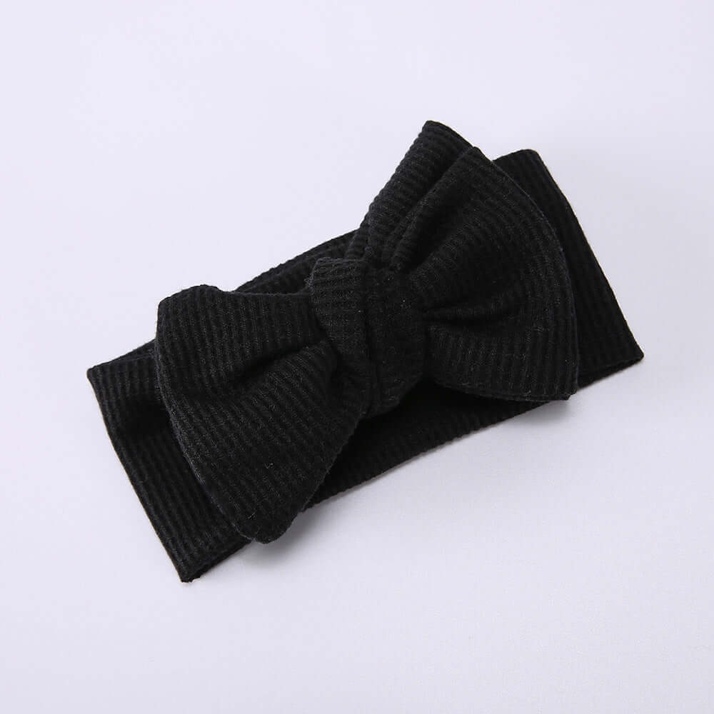 Children's Waffle Knit Oversized Bow Headband in black, featuring a large textured bow for a stylish look.