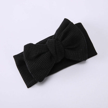 Children's Waffle Knit Oversized Bow Headband in black, featuring a large textured bow for a stylish look.