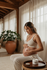 Pregnant woman applying belly cream